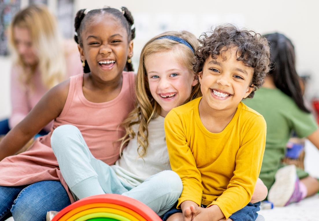 Happy children aged 8 to 10 smiling inside Horizon Kids Club hall