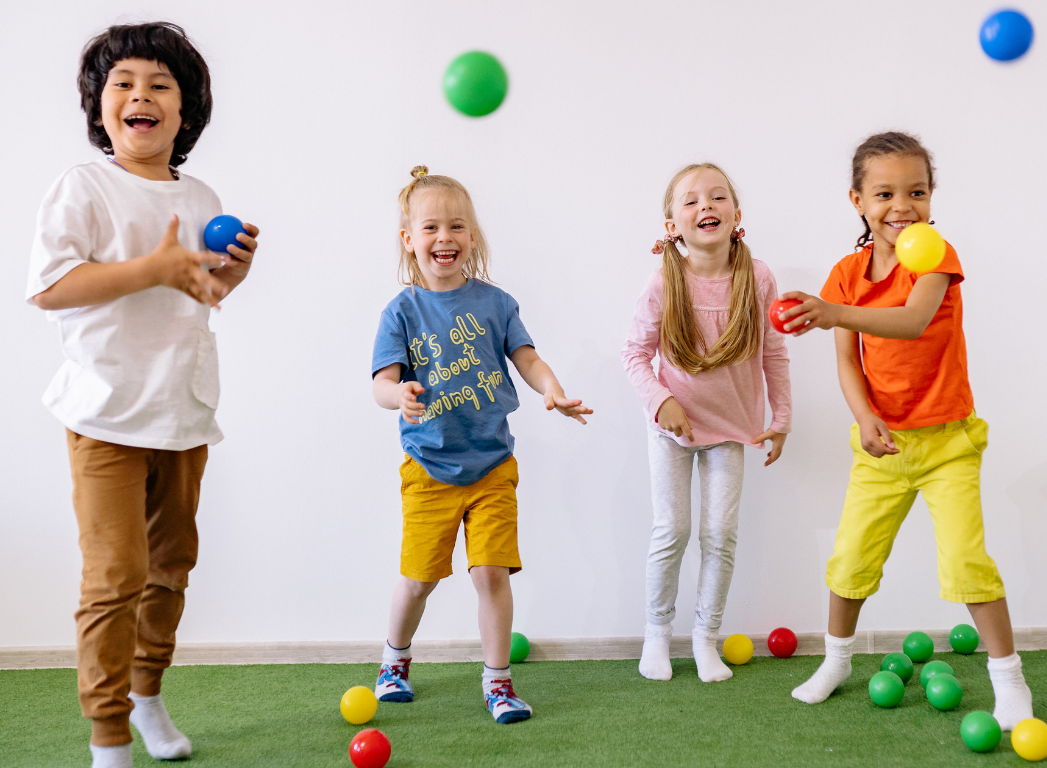 Children aged 8 playing ball games inside Horizon Kids Club hall