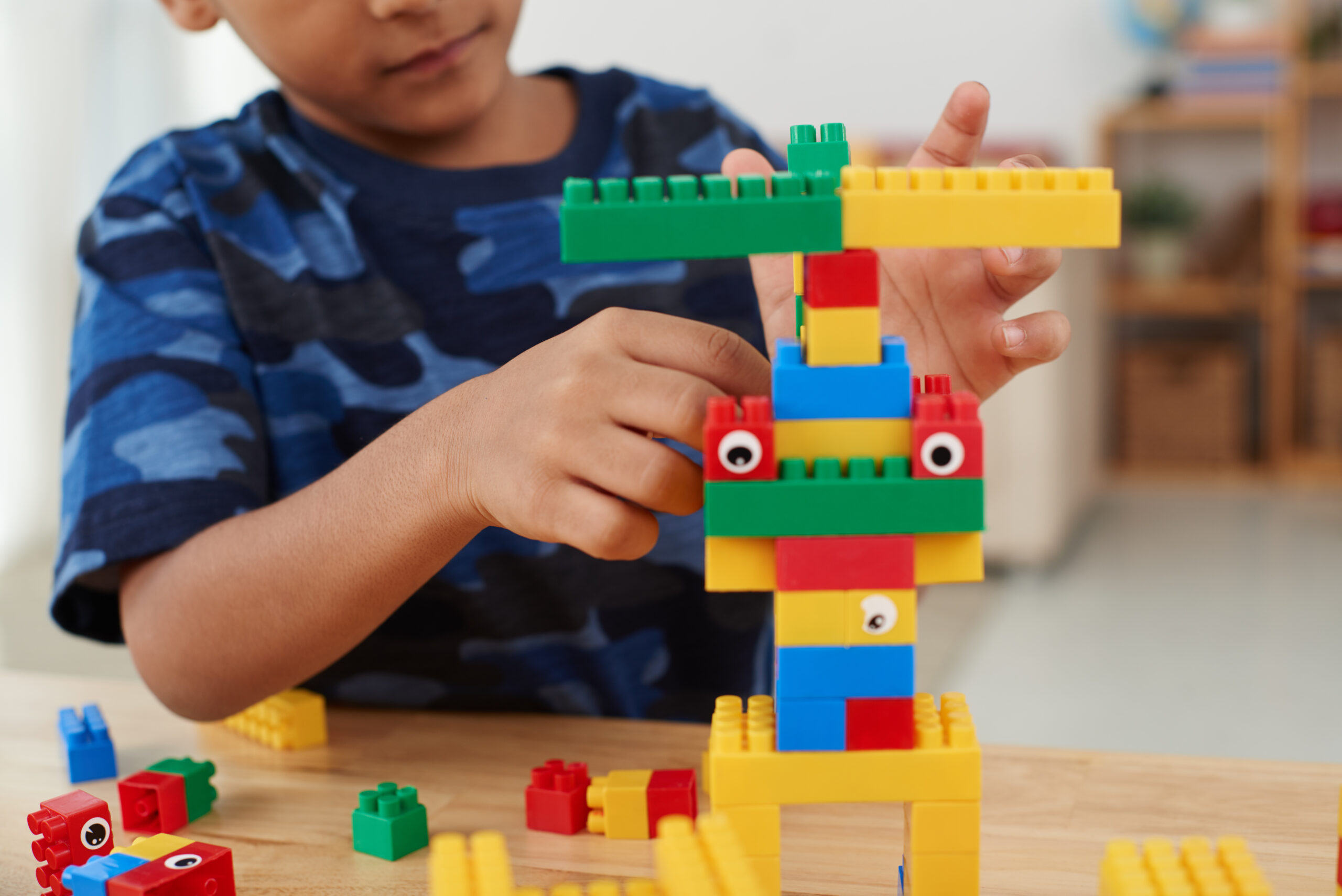 Boy playing with colourful cubes during a hands-on learning activity