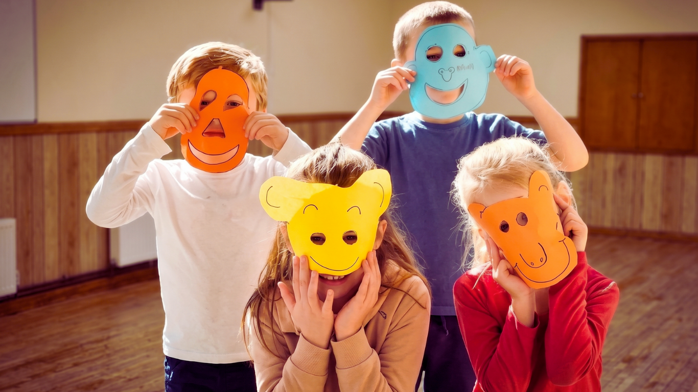 Children wearing paper masks after an origami activity at Horizon Kids Club