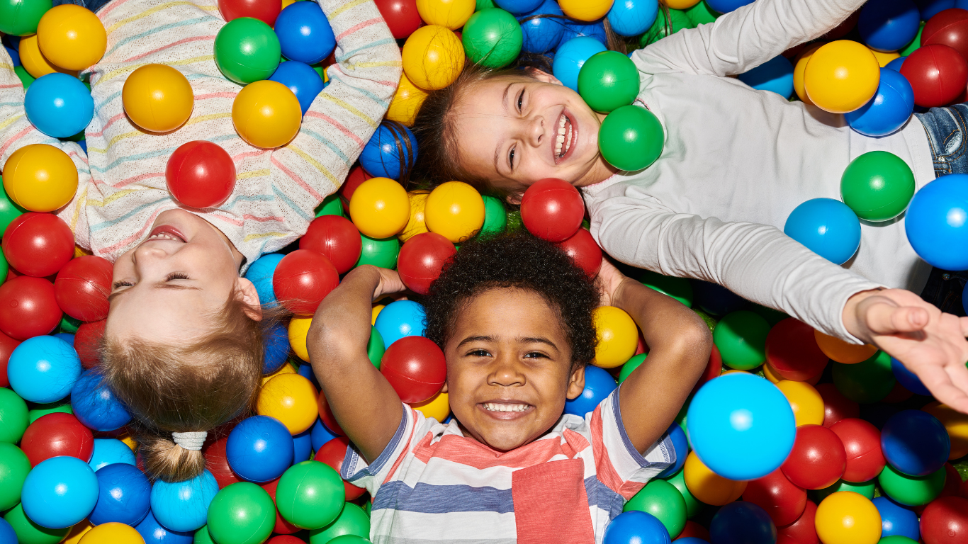 Little kids playing in a ball pitt